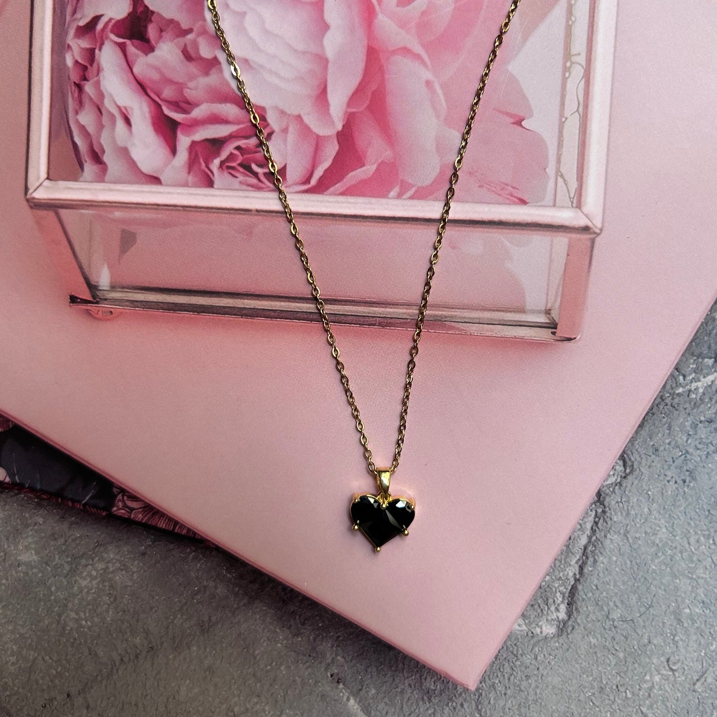 Black stone heart pendant with golden chain necklace