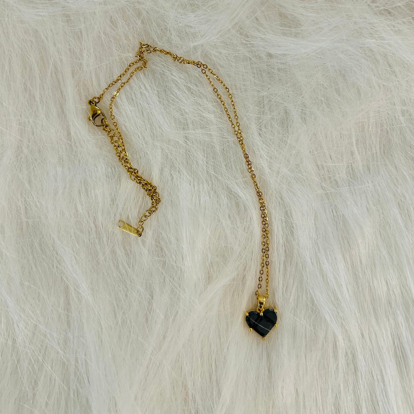 Black stone heart pendant with golden chain necklace